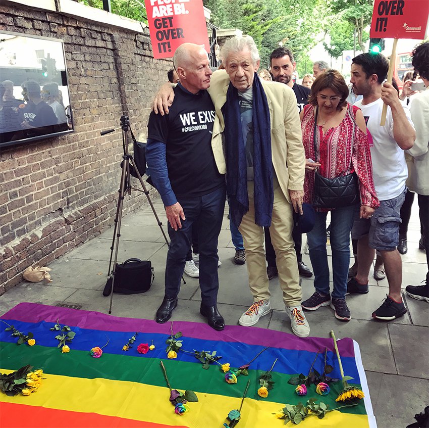 Michael Cashman, member of the House of Lords, and Ian McKellen, lay rainbow roses on a rainbow flag outside the Russian Embassy