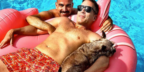 Carlos [center] with his husband Rubin and their pet dog Bruna