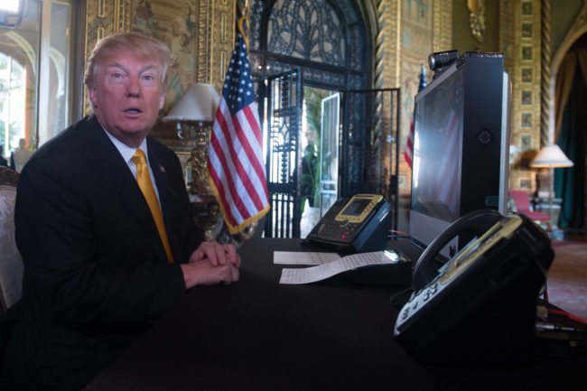 US President Donald Trump prepares his traditionnal adress to thank members of the US military via video teleconference on Thanksgiving day, November 23, 2017 from his residence in Mar-a-Lago in Florida. The US President is spending the Thanksgiving holidays in his Florida private residence until November 26. / AFP PHOTO / Nicholas KAMM (Photo credit should read NICHOLAS KAMM/AFP/Getty Images)