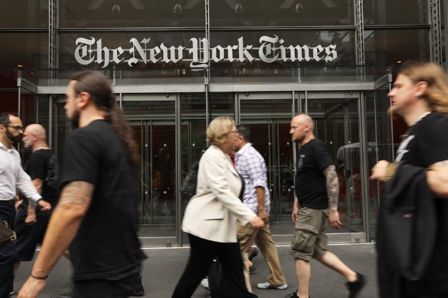 NEW YORK, NY - JULY 27: People walk past the New York Times building on July 27, 2017 in New York City. The New York Times Company shares have surged to a nine-year high after posting strong earnings on Thursday. Partly due to new digital subscriptions following the election of Donald Trump as president, the company reported a profit of $27.7 million in the second quarter, up from $9.1 million in the same period last year. (Photo by Spencer Platt/Getty Images)