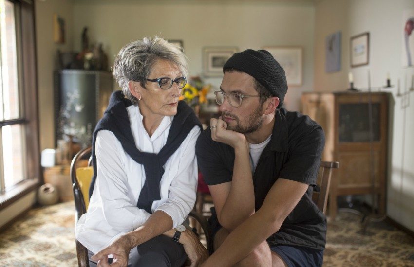 A mother and son sitting next to each other at home