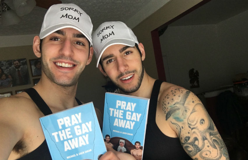 Michael and Zach Zakar holding their book Pray the Gay Away