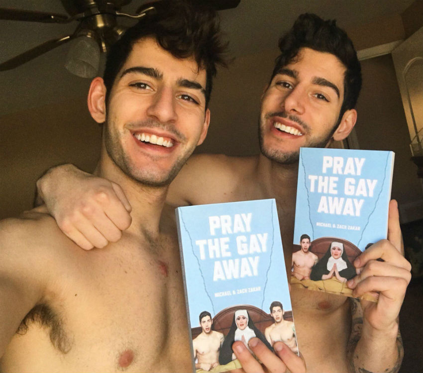 Zach and Michael Zakar holding their book, Pray the Gay Away