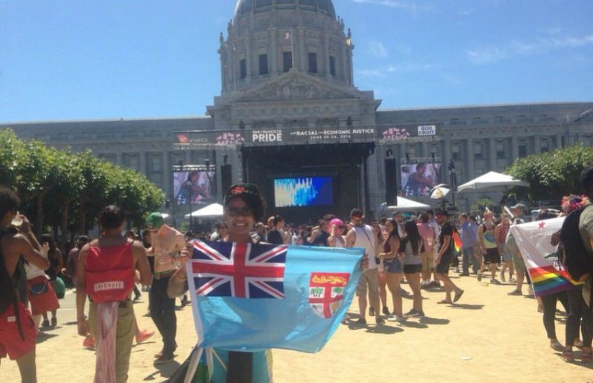 Woman holds Fijian flag at concert