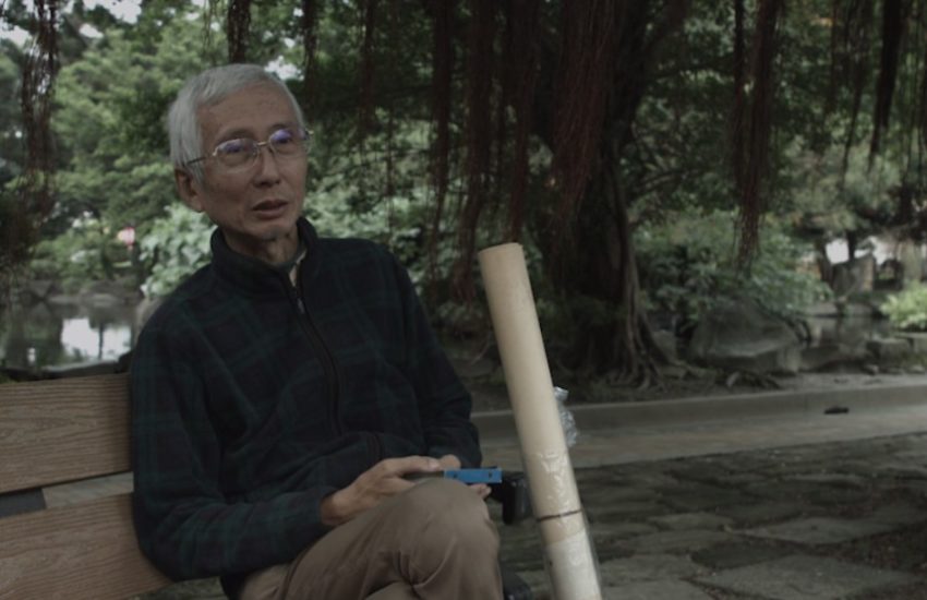 Chi Chia Wei sits on a single seat in the park