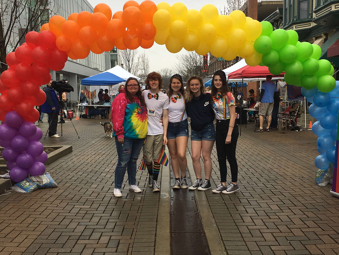 Friends under a rainbow arch in Columbus