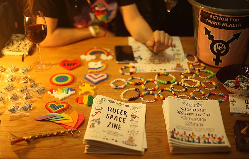 Leaflets and rainbow souvenirs on sale at Queer Space.