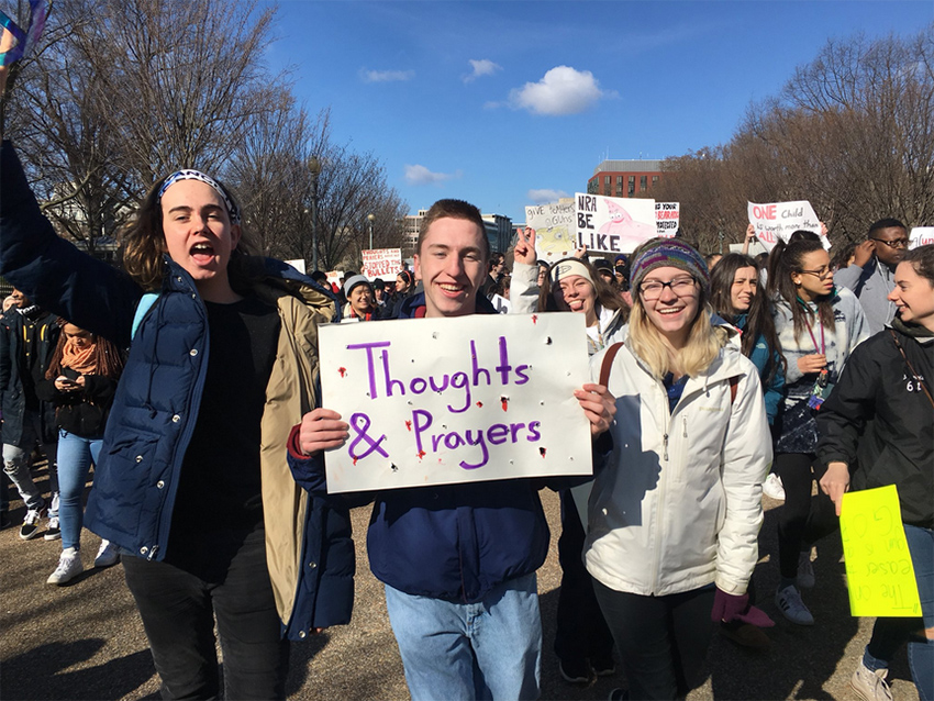 High school director Saul Singleton, middle, at an anti-NRA protest