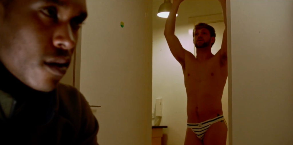 Joe pretends to be confident, but is the jockstrap just part of a outfit and persona? | Still from The Grass is always Grindr by 56 Dean Street