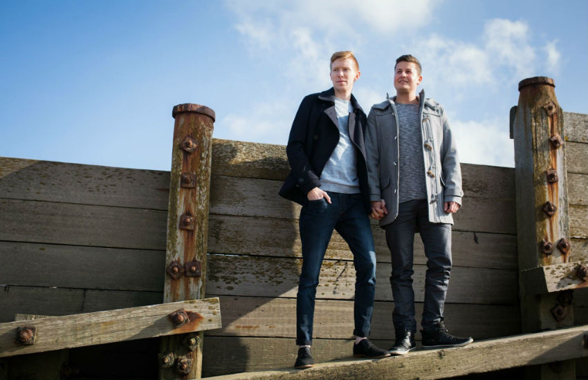 Tom Bosworth and Harry Dineley standing together holding hands 