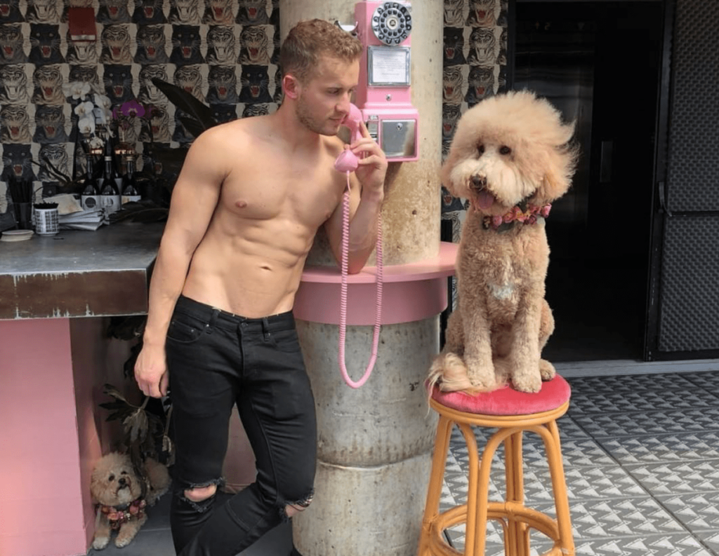 HOLD THE SHOOT, got to take this. | Photo: Provided to Gay Star News by @HotDudesWith Dogs Instagram