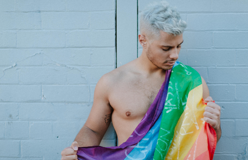 Jordan Bruno wearing a rainbow flag