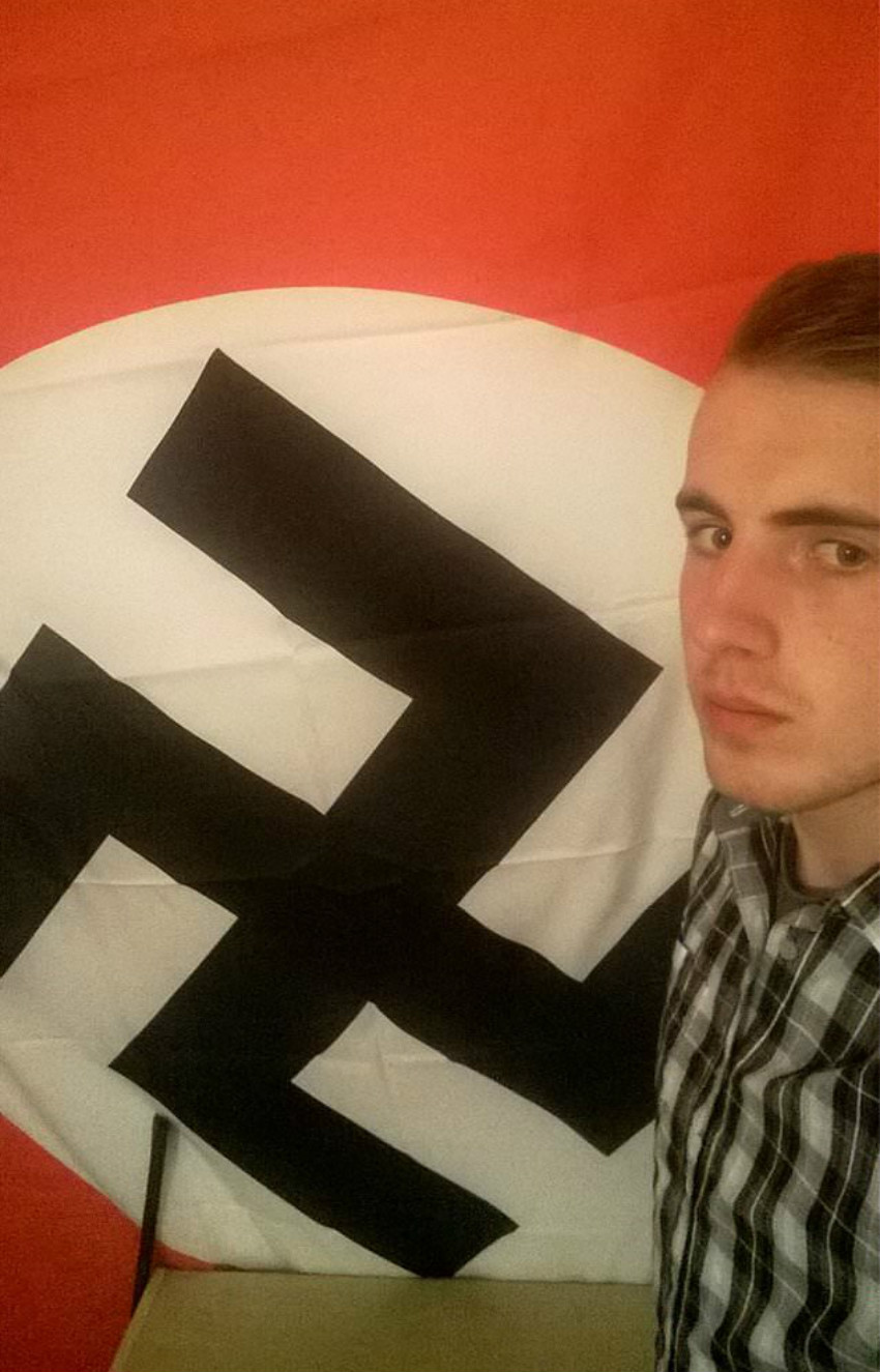 Ethan Stables poses with a Nazi flag