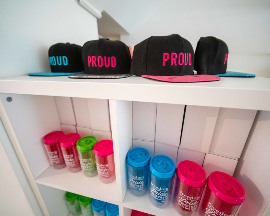 A baseball cap and a few water mugs at the Pride in London's pop-up shop.