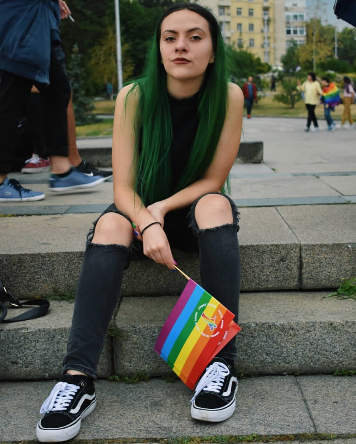 A girl posing with the rainbow flag
