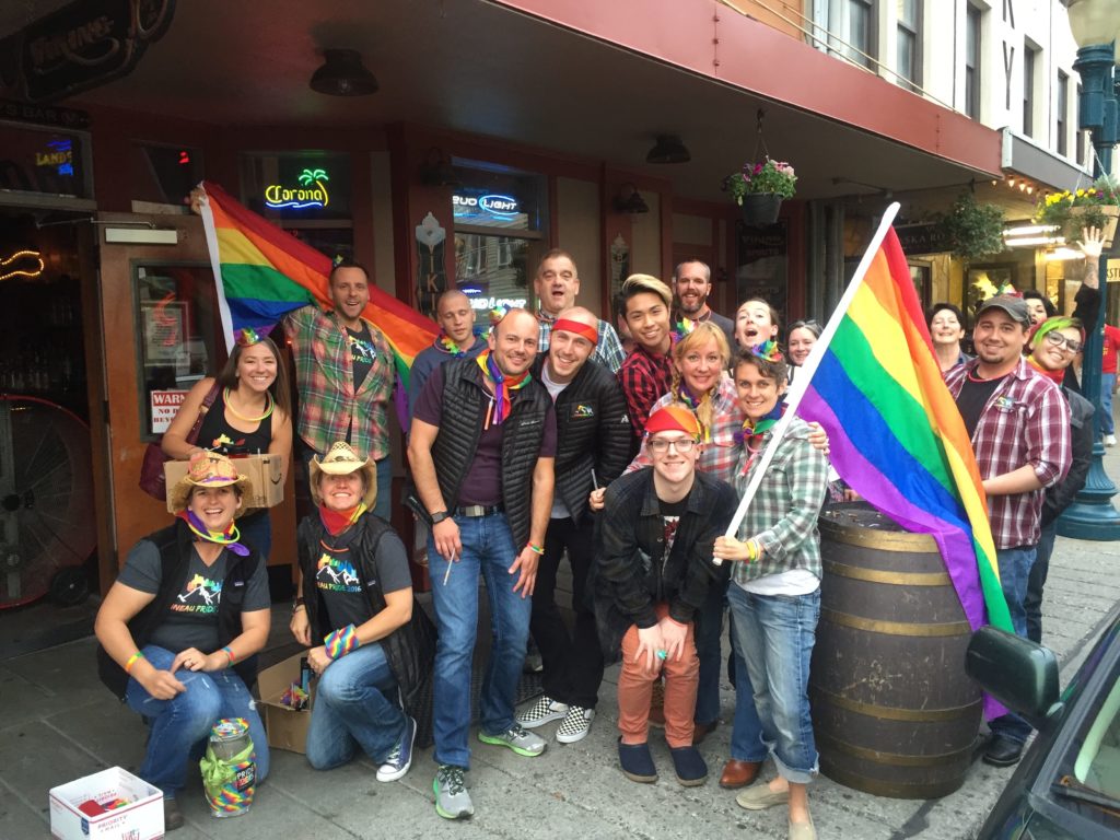 Marchers stopping for a quick pint at a pub during Juneau Pride