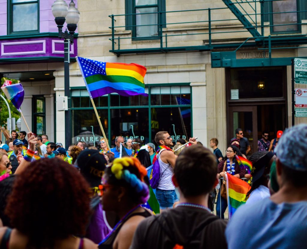 Marchers waving the rainbow flag at Iowa City Pride Festival