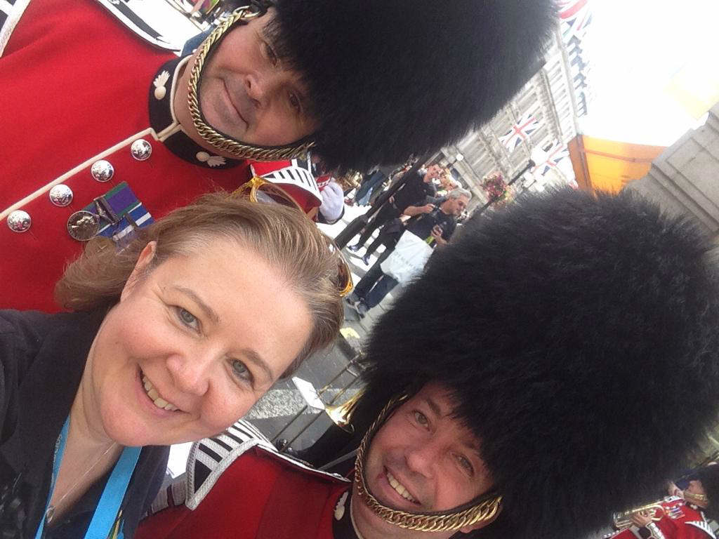 Alison Camps posing for a selfie with two guards at Pride 2017