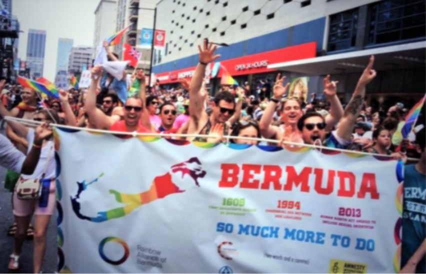 Bermuda Pride contingent of people standing behind bermuda banner