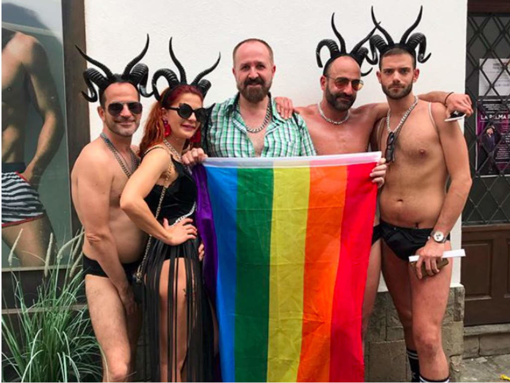 Performers posing with the rainbow flag at Sitges Pride