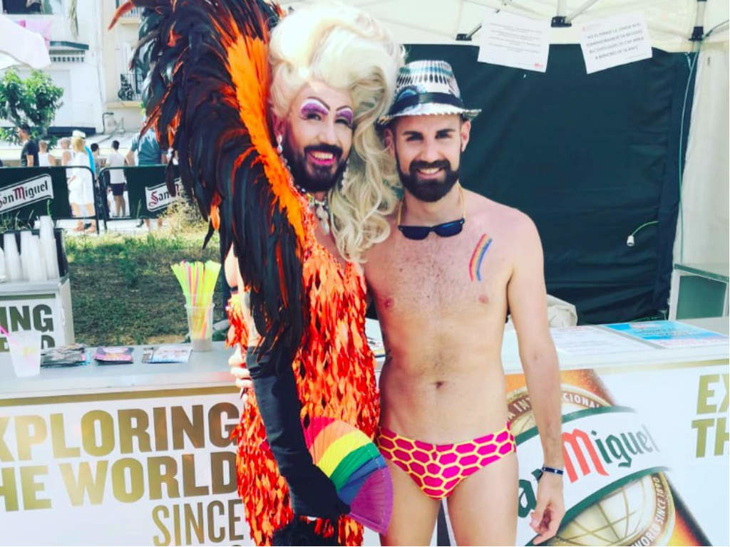 A drag queen posing with a shirtless guy in Sitges
