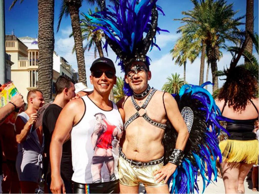 A man posing for a picture with a performer