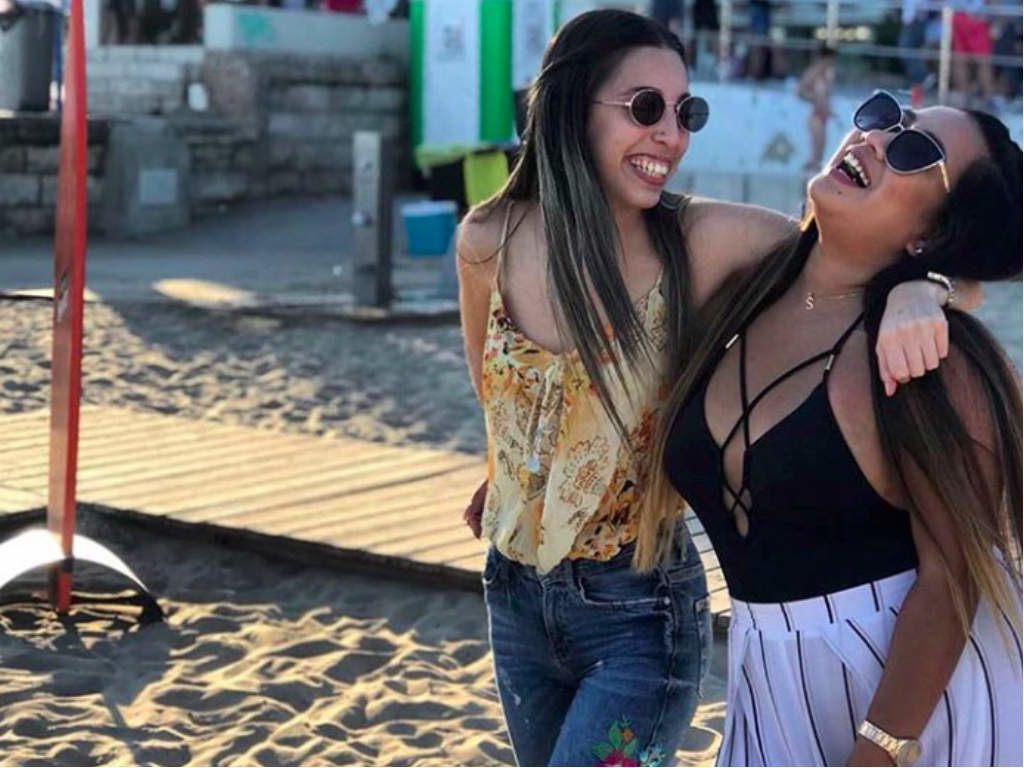 Two girls laughing on the beach during Sitges Pride
