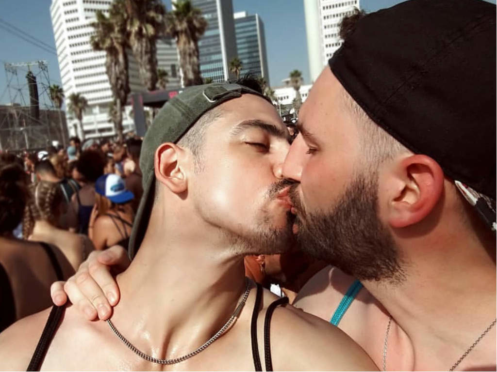 Two men kissing at the parade