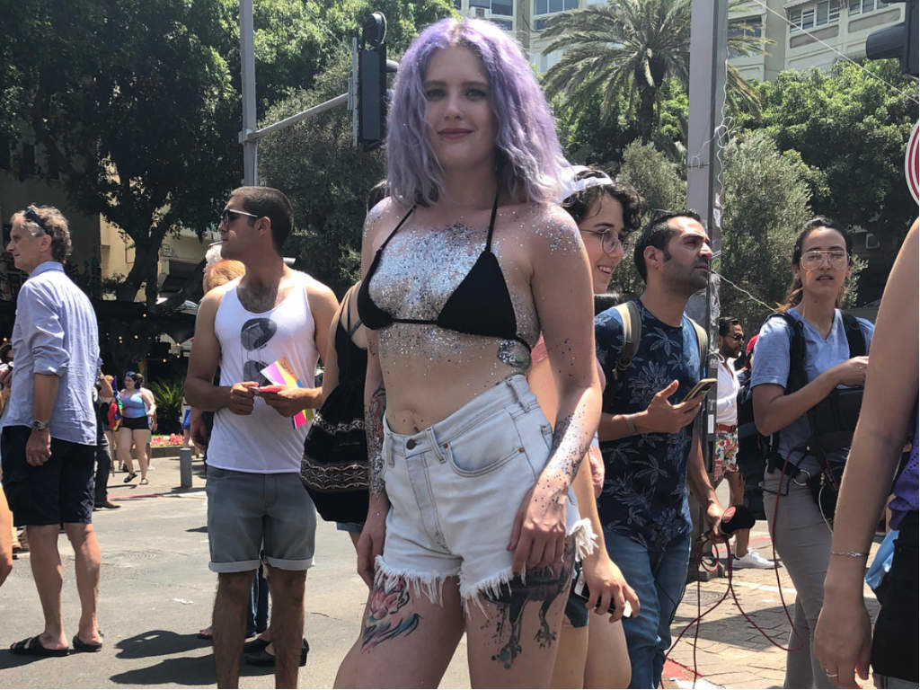 A lilac-haired girl covered in glitter at Tel Aviv Pride