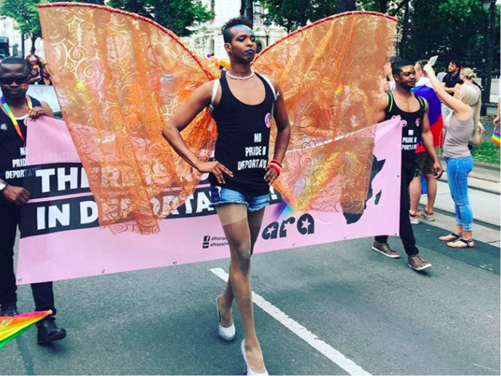 A performer wearing orange wings leading one of the walking groups