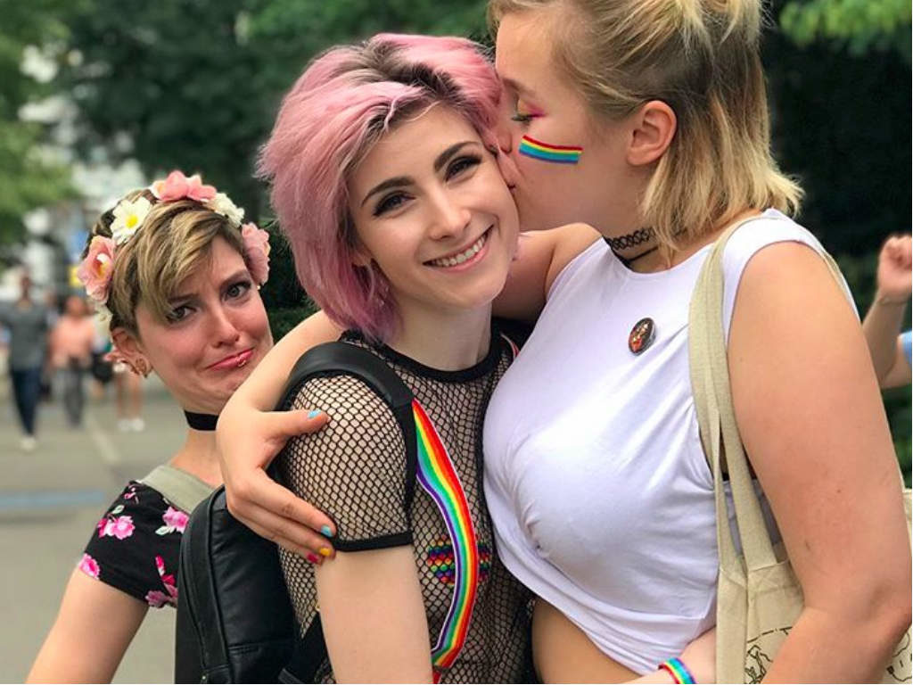 A girl kissing another girl on the cheek at Vienna Pride