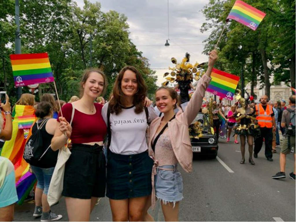 Girls waving the rainbow flags at the parade