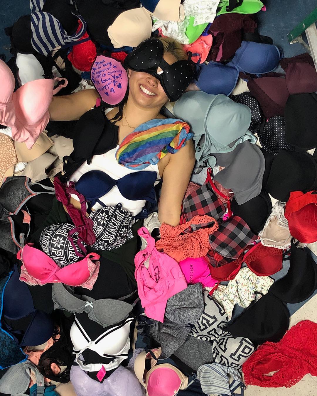 Hayley Kiyoko lying in the pile of bras