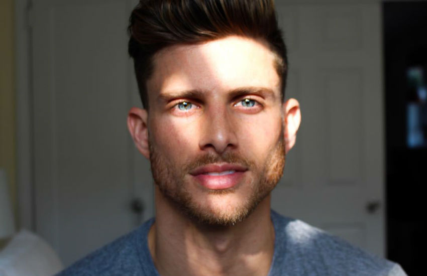 Gay male model Barrett Pall posing with light on his face