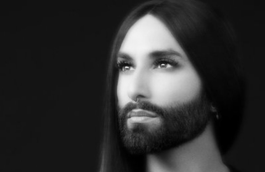 A soft focus black and white shot of conchita wurst she's is looking up at an angle away from the camera