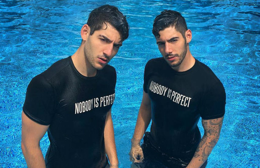 Michael and Zach Zakar pose in t-shirts that read 'Nobody is Perfect'