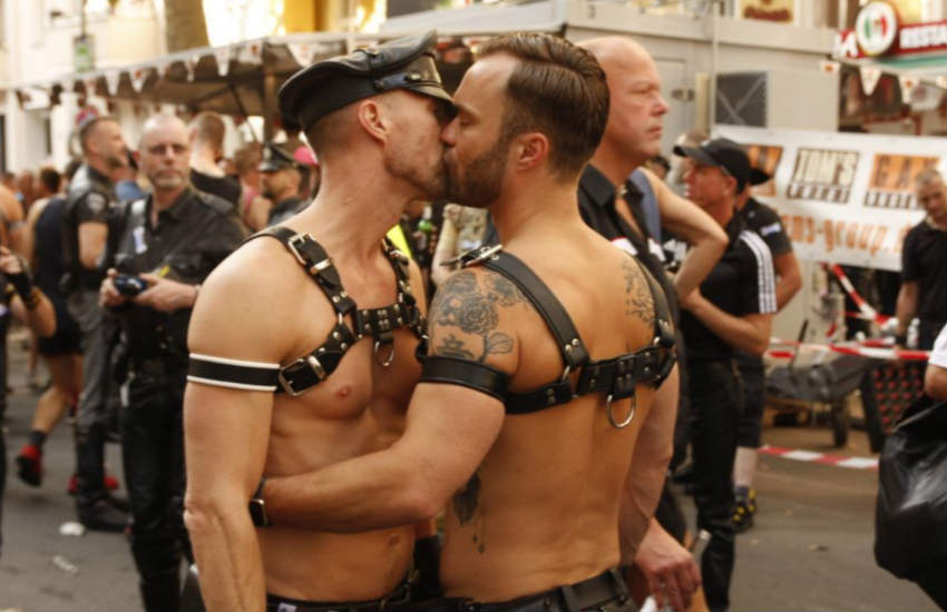 Two men kissing at Folsom Europe Berlin 2016.