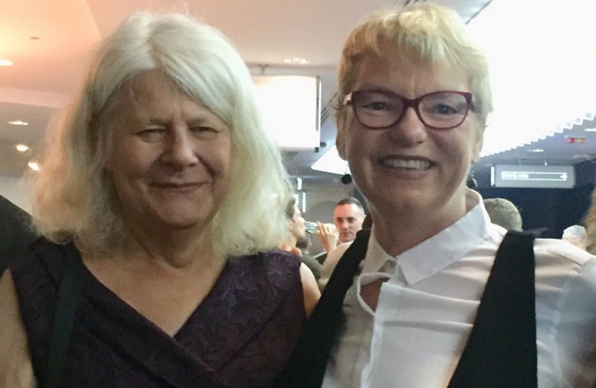 Penny Whetton with her wife Australian Greens Senator Janet Rice smiling and standing