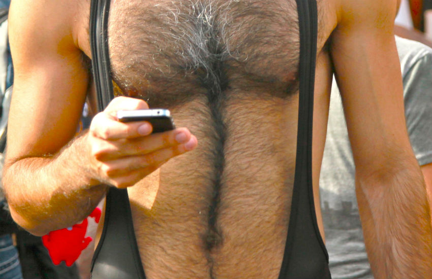 Man in leather outfit holding his phone