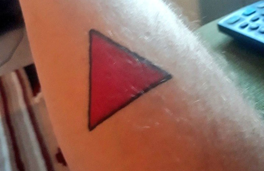 Nick McGlynn's pink triangle tattoo