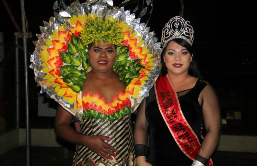 two trans women in glamourous dresses, on is wearing a tiara