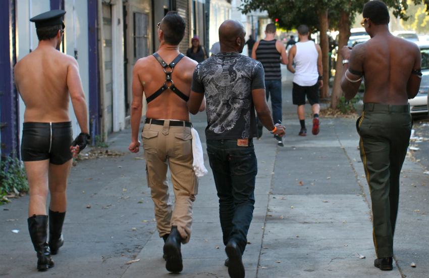 Four men walking down the street in kink and fetish wear