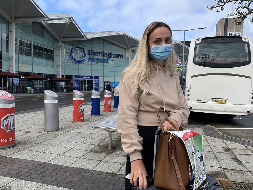 Emma Rhodes, a 21-year-old student, arriving back at Birmingham Airport on a flight from Dubai today. She said she boarded the 'packed' flight to Birmingham, having originally been set to come home on an Emirates flight destined for Manchester